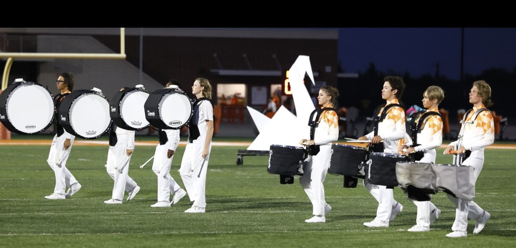 Marching band walking up the field